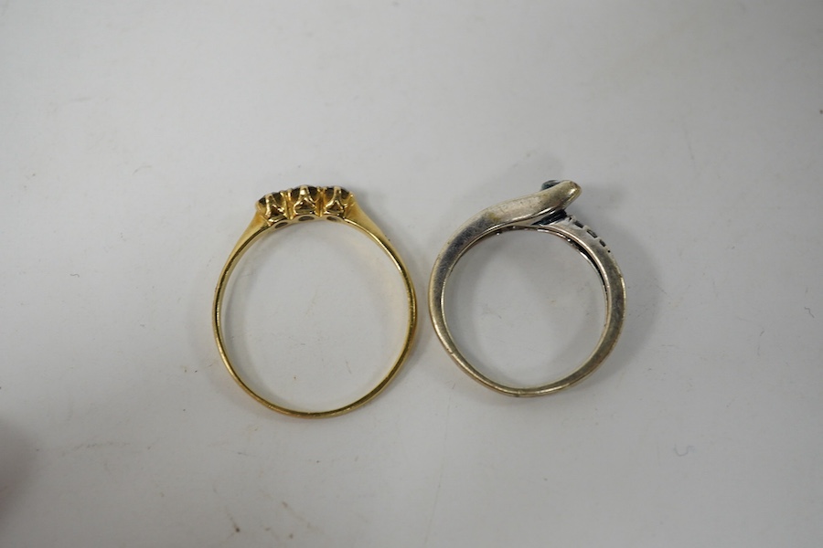 A small yellow metal and three stone diamond set ring, size R/S and a modern 9kt and single stone diamond ring, with diamond chip set shoulders, gross weight 4.3 grams.